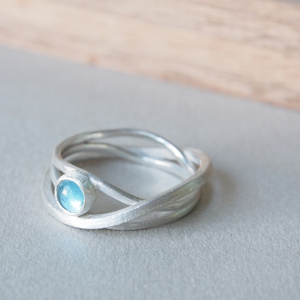 Anillo Etapas de plata con cabujón redondo de topacio azul